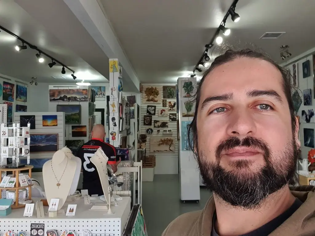 A man standing in front of a display case.