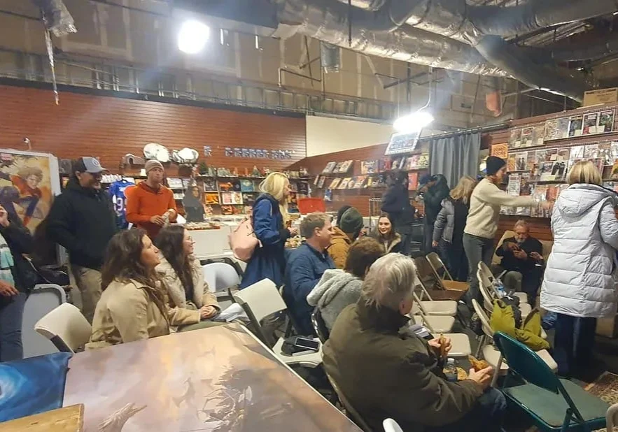 People gathered in a comic book store